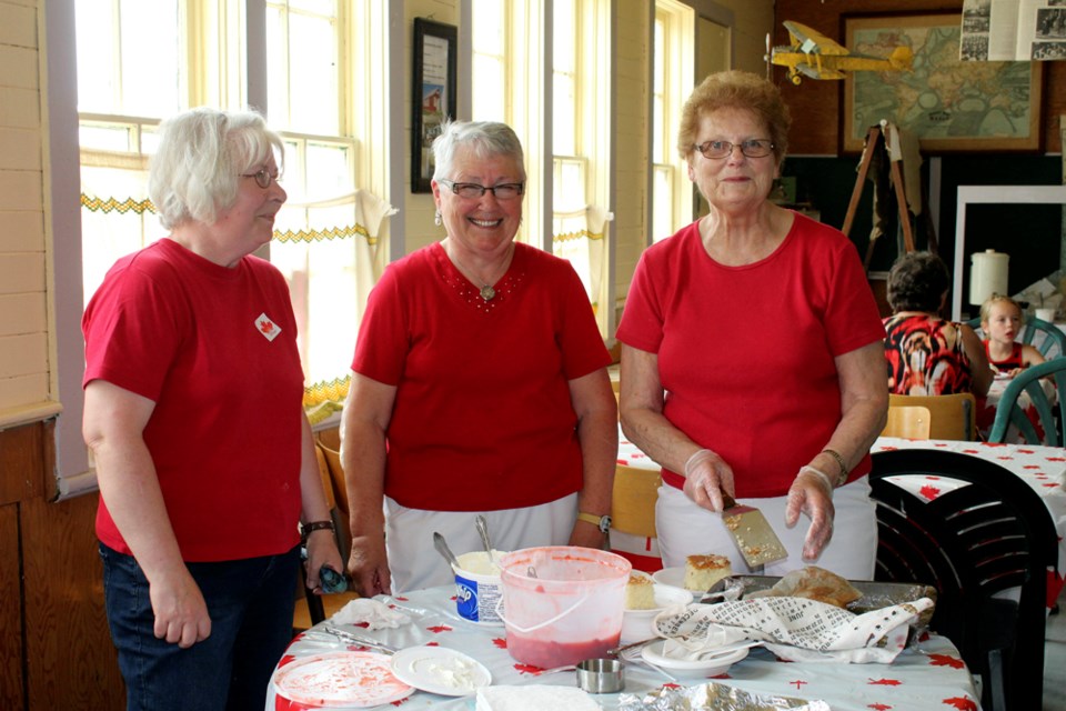 Strawberry social in the one-room schoolhouse is one of the many Canada Day features in Elkhorn on July 1. Margaret James, Lil Jackson and Mavis Allum serve up the dessert - a fundraiser for the museum’s newest acquisition, the Century Farm House.