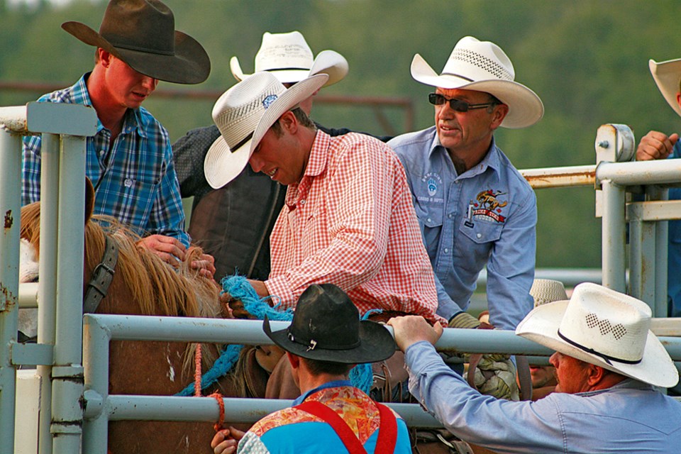 Kirk Thompson of Oak Lake, getting ready to ride Outback Jack in the saddle bronc event at Moosomin Rodeo Friday, July 3.