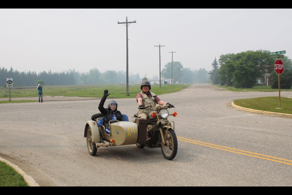 Ann Randall at 91 years young is decked out in leathers and helmet as she and Ed James, driver and owner of the WWII replica German Army Afrika Korp BMW, tour Elkhorn on July 6.