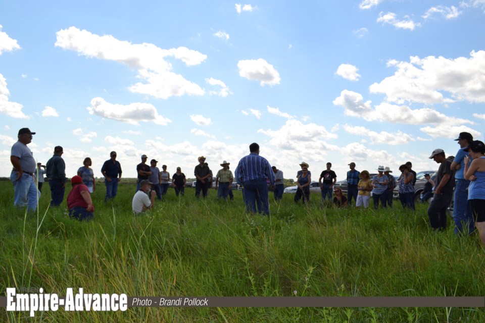 Larry Wegner (c) explains to the group about rotational grazing.