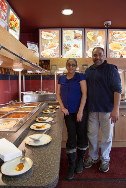 Kal and Bel Singh stand in front of Butter Chicken Express’s sumptuous buffet.