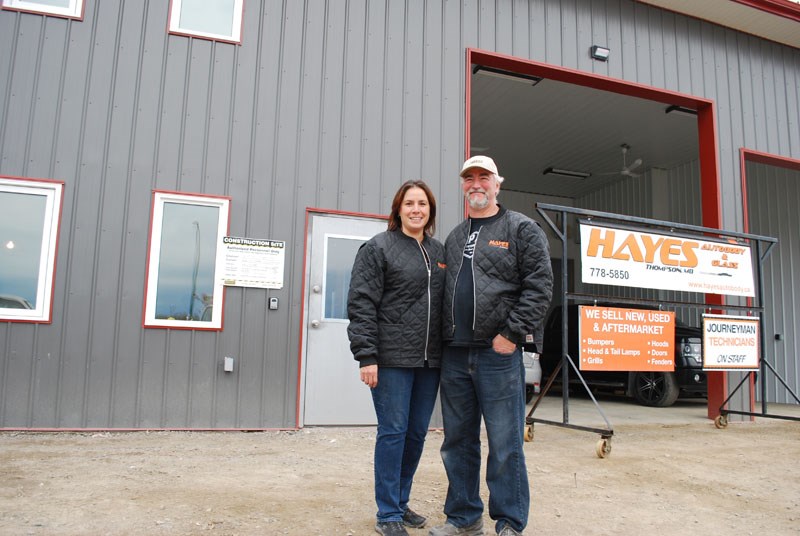 Jo-Ann Adam and Doug Sime in front of the new addition being constructed at Hayes Auto Body & Glass.