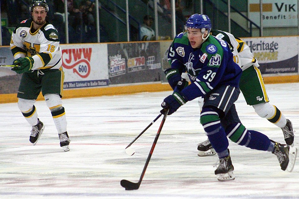 Reed Gunville tries to weave his way through four Humboldt Broncos during Saskatchewan Junior Hockey League action in Humboldt on March 8. Humboldt Journal Photo/Christopher Lee