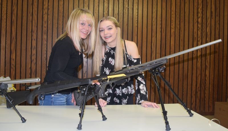 Leanne Romaniuk and her daughter Keanna inspected the rifles which were on display during the wildlife awards banquet held at Kamsack on February 25.