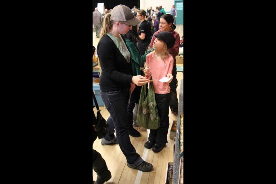 Eight year old gardener Sophie Jankowski (right) is getting ready for the growing season, with seeds and advice from Rachelle Ternier from Prairie Garden Seeds at the Seedy Saturday event at Dr. Brass School.