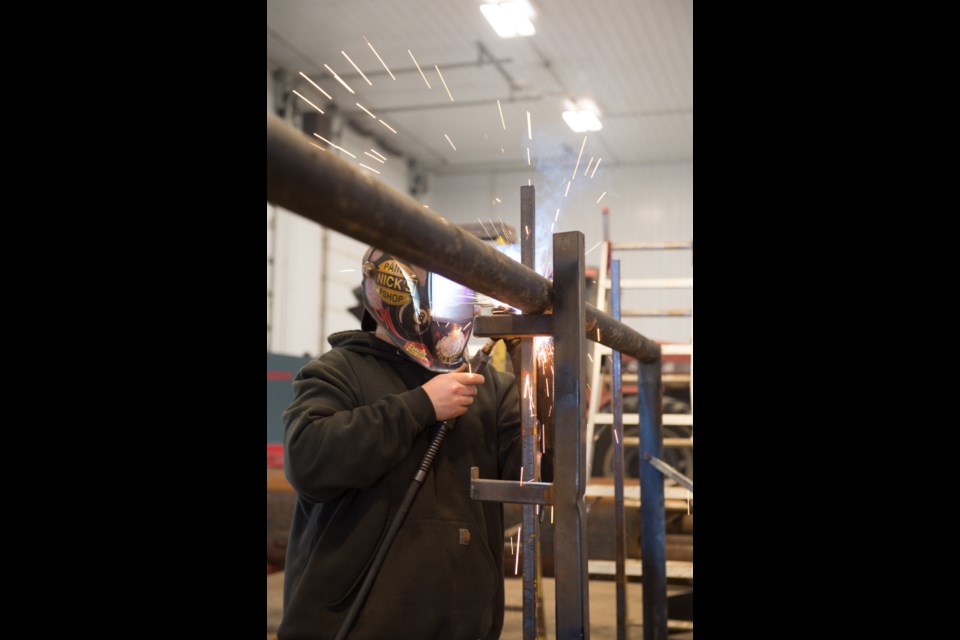 Chance Bayliss works on cattle-related items at Mains Welding.