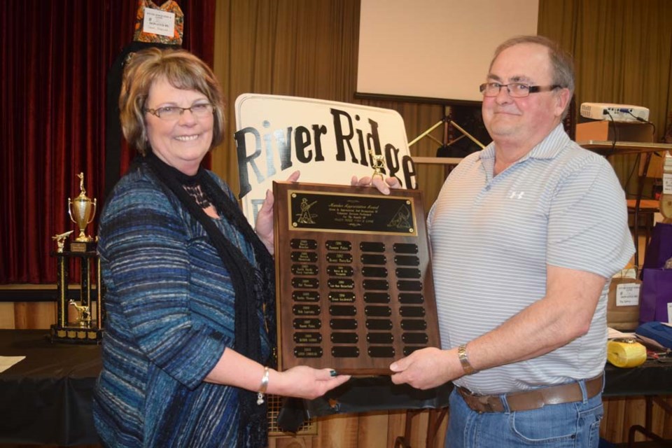 Kathy Thomas, president of the River Ridge Fish and Game League branch of the Saskatchewan Wildlife Federation, presented the member recognition award to Ernie Gazdewich, who is the member who organizes the branch’s annual gun show.