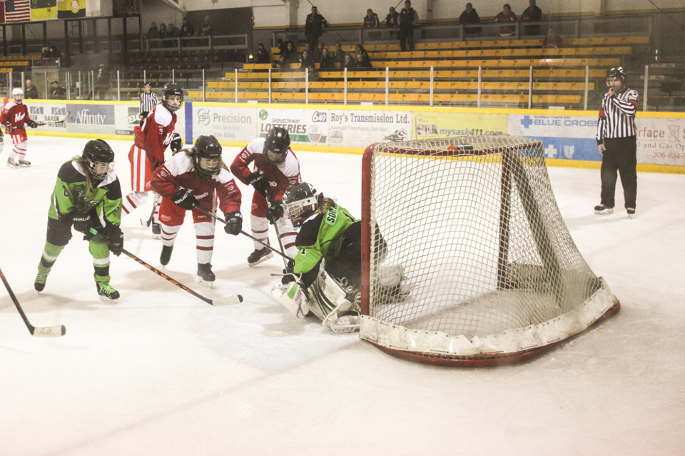 Vipers goalie Chloe Sorenson drops down to make a save as Kennedy Dowhanuik (6) and members of the M