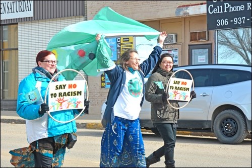 ori Nicotine, a member of Water is Life: Treat 6, the Battlefords, carries the flag for International Indigenous Unity March 21, to mark City Hall's proclamation for the International Day for the Elimination of Racial Discrimination. The initiative was organized through a partnership between Battlefords Immigration Resource Centre and the Multicultural Council of Saskatchewan. Photos by Shannon Kovalsky