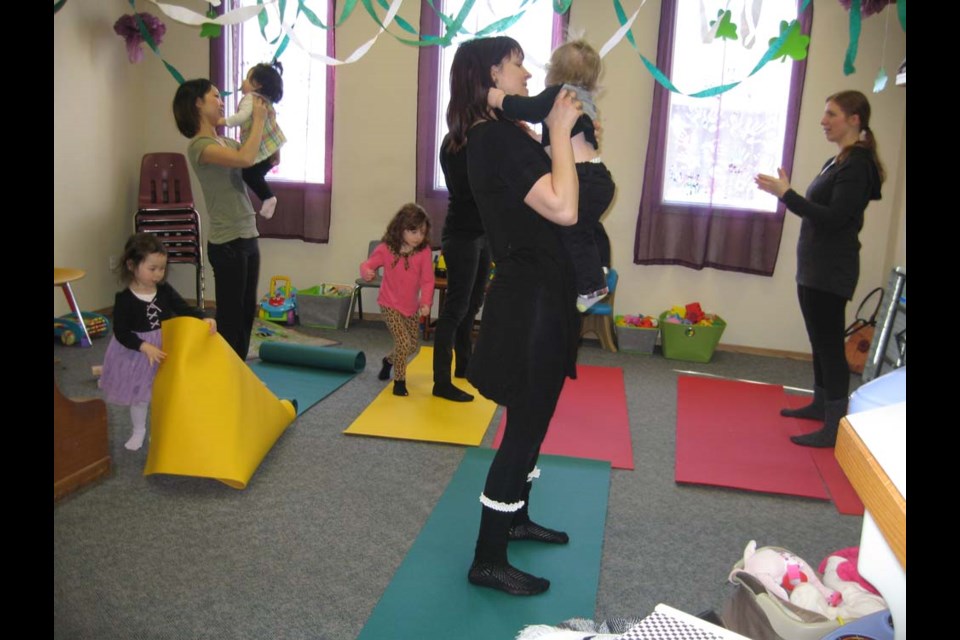 Leanne Popoff from Admyred Yoga & Wellness Studio was teaching yoga to parents of newborns and children up to 18 months of age. Gillian Rice with her son Lowell Rice is in front, while to the left is Masako Knight and her daughters Emma and Maya Knight.