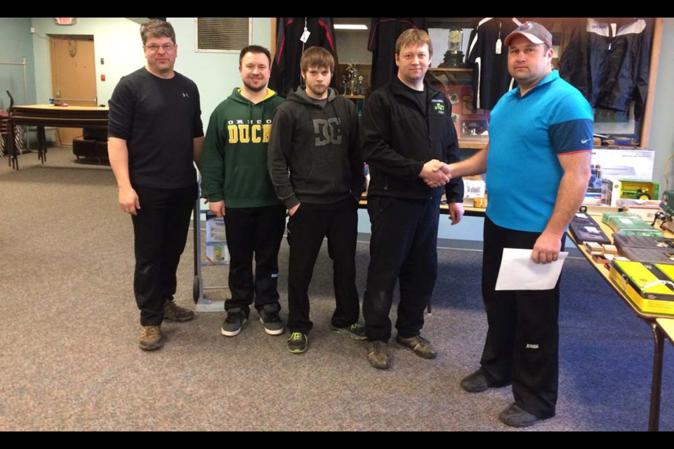 John Zbitniff, right, vice-president of the Canora Curling Club, congratulated the Ken Newell rink of Norquay for having won the A event of the Canora Men’s Bonspiel played March 8 to 12. Members of the winning rink, from left, were: Kevin Ebert, Evan Rostoski, Zach Newell and Ken Newell.