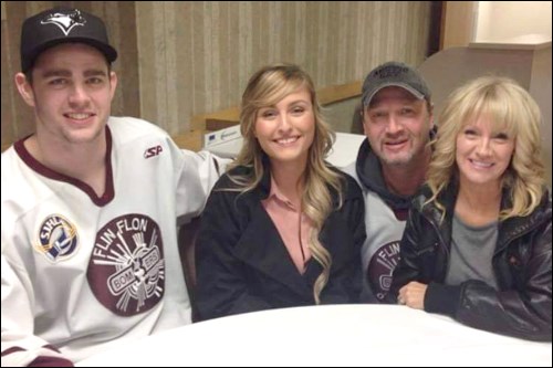 Former Flin Flon Bomber Brody Robinson poses with girlfriend Melisa and his former billet parents.