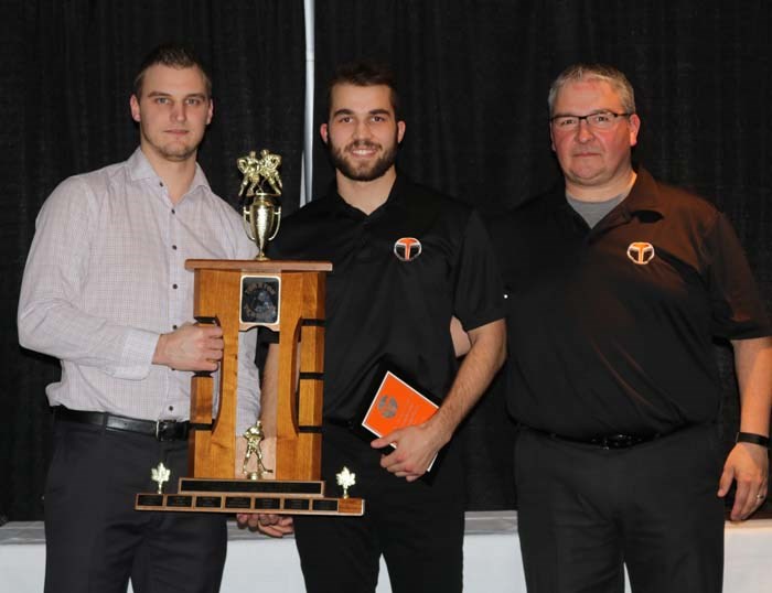 Terriers’ graduating captain Corwin Stevely (middle) accepts the Most Valuable Player award from assistant coaches Mat Hehr (left) and Scotty Musqua (right).
