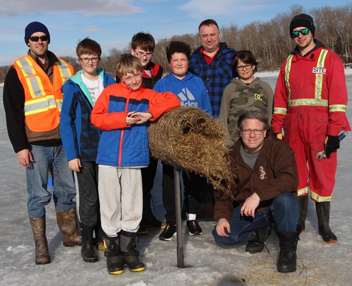 Jesse Nielsen with the Assiniboine Watershed Authority and Yorkton’s Zion 8 Boy Scouts with one of the completed mallard duck nesting tunnels, installed at the Ravine Ecological Preserve.