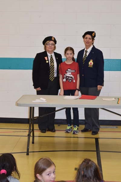 Debbie Gabora (left) and Pat Thompson of the Royal Canadian Legion Canora Branch congratulated Sofia Tratch, Grade 4 student and third place winner in the grades 4 to 6 group colour poster category, while the Legion’s Pat Thompson looks on.