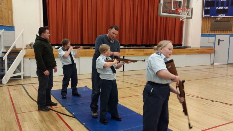 Cst. Conal Shepherd, left, of the Kamsack RCMP, and 2nd Lieut. Jon Neima of Powerview, Man., worked with Kamsack air cadets during a recent rifle practice. The cadets, from left, were: Traistan Chernoff, Zach Chernoff and Tara Taylor.