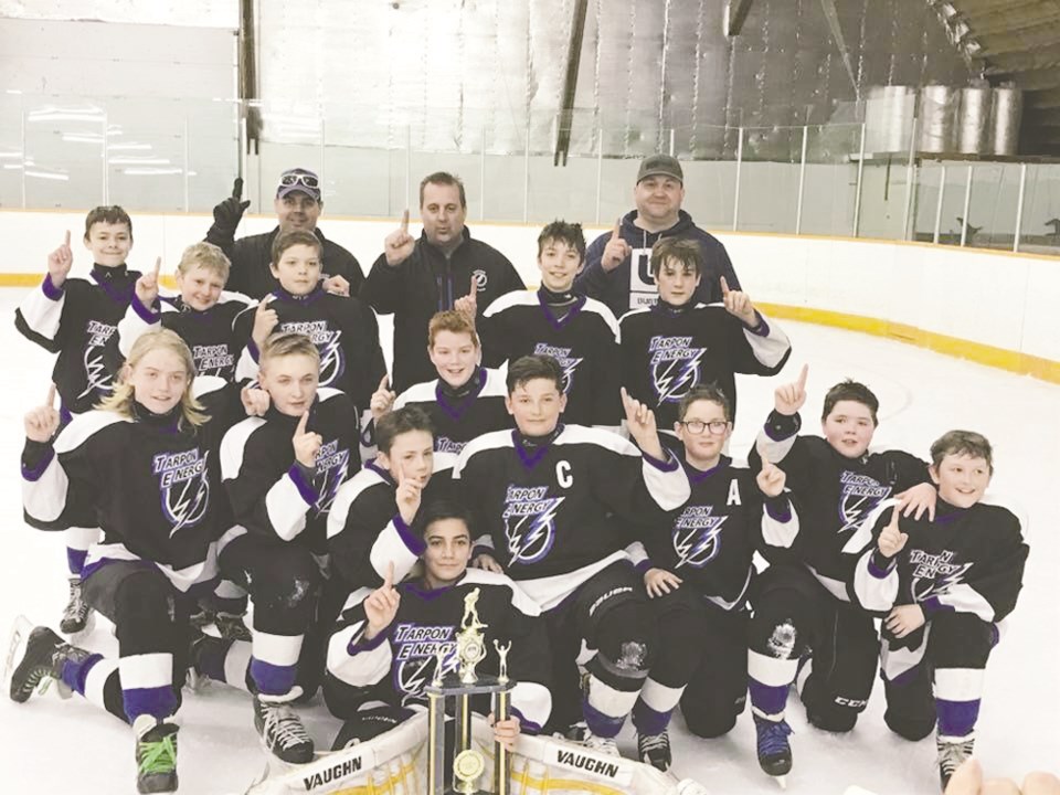 The Estevan Tarpon Energy peewee Storm celebrate after winning the league title over Radville. Photo
