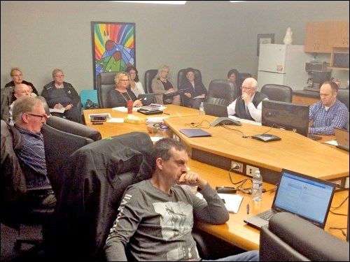 The Living Sky School Division board watches the presentation by conference call of Director of Education Dave Hutchinson, who outlined options to address a $6 million deficit the school division faces in 2017-18.  Photos by John Cairns