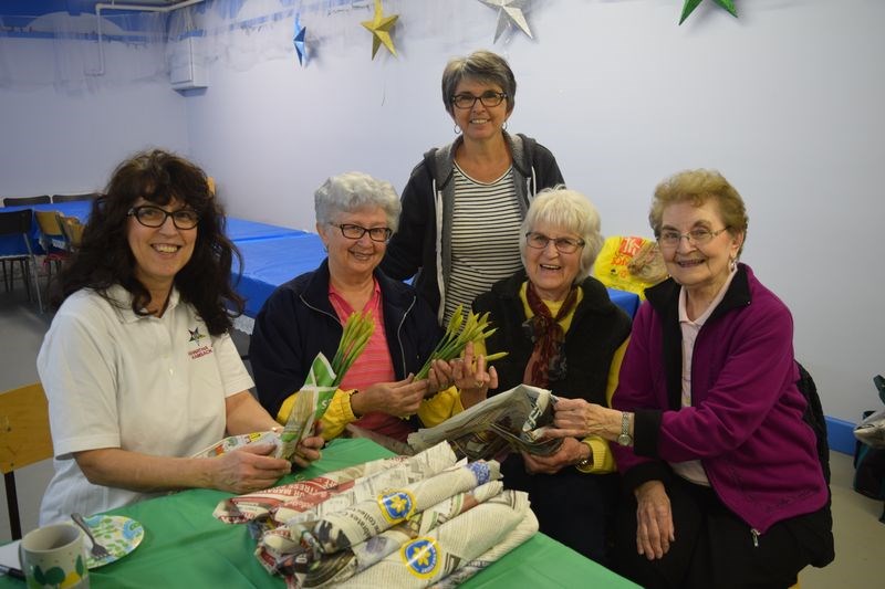 A total of 3,770 yellow daffodils were blooming in Kamsack last week after members of the Hiawatha chapter of the Eastern Star at Kamsack received them on April 4 and sold them to raise money for the Canadian Cancer Society. At work as volunteers bundling the daffodils, from left, were: Melina Hollett, Judy Stone, Susan Bear, Marj Orr and Mary Welykholowa.