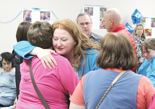 Paula Bali, whose daughter Mekayla went missing April 12, 2016, hugs a supporter following a one-year anniversay prayer vigil last Wednesday evening at the SIGN building on Broadway Street West. Bali refuses to give up hope that Mekayla will be found.