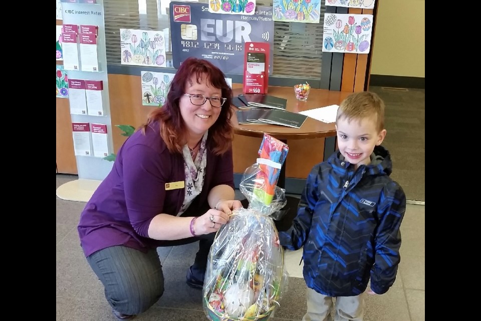 Isaiah Faryna, 4, received his prize from Elly Carlson of the CIBC in Canora, on April 13 for being one of the winners of the CIBC Canora Easter colouring contest.