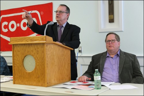 Co-op board president Dave Kendall fields questions as Tom Therien looks on.