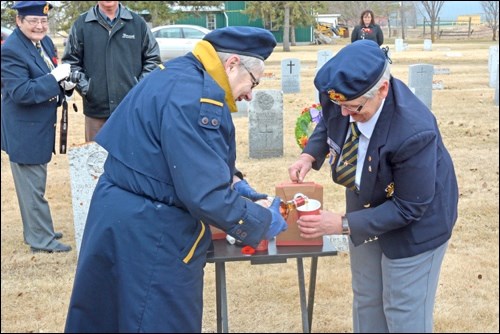 Candice Brown and Louise Oster of North Battleford Royal Canadian Legion prepare the "gunpowder toast," a mixed drink of coffee and rum.