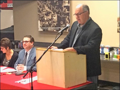 With general manager Mike Nord sitting beside the podium, board President Rob Squair chairs the Discovery Co-op's annual general meeting which took place Tuesday night at the Territorial Place Co-op cafeteria. Photos by John Cairns