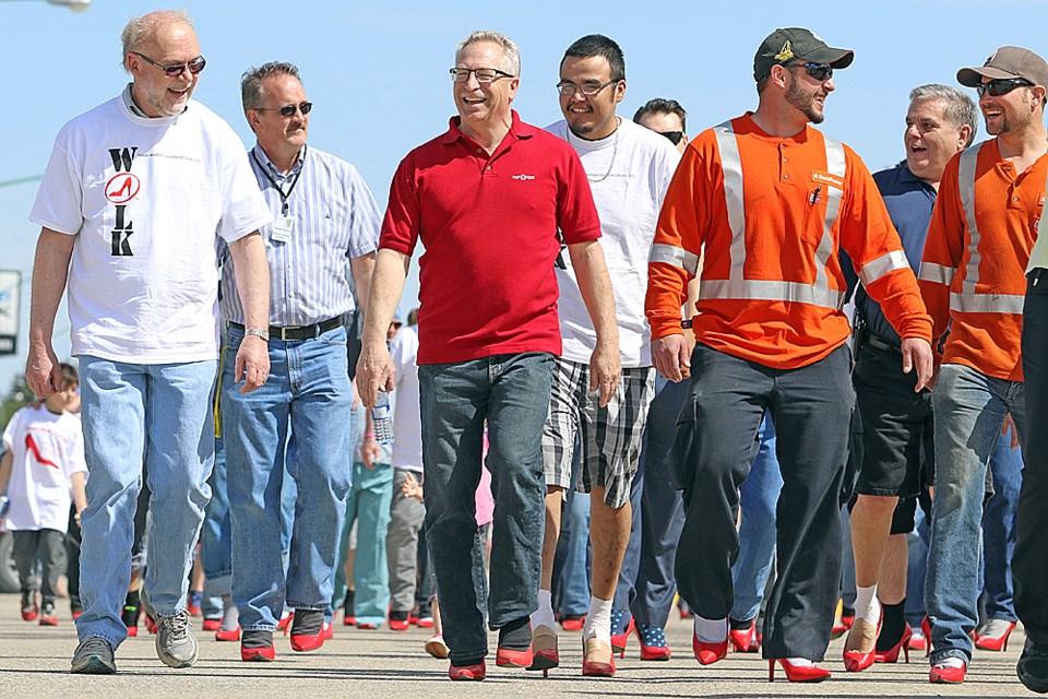 Fifty men march down Nipawin's Main Street to take a stand against violence against women May 4. Review Photo/Devan C. Tasa