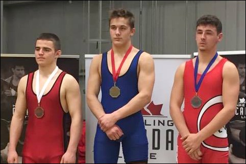 Flin Flon’s Carson Lee (middle) with his national gold medal.