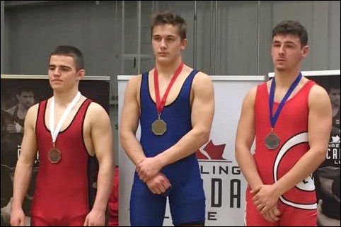 Flin Flon’s Carson Lee (middle) with his national gold medal.