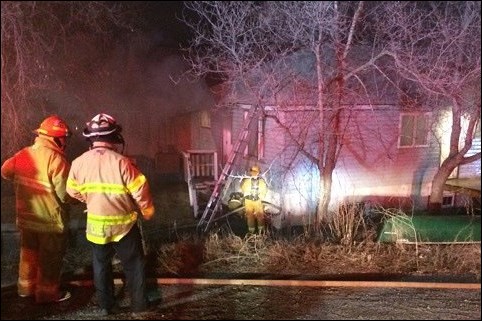 Firefighters at the scene of a Ross Street house fire on May 3.
