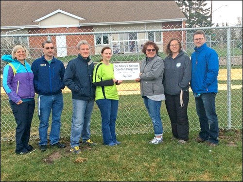 At the St. Mary ground blessing ceremony are: Amanda Risling, Vice-Principal; Karl Volk, Custodian;