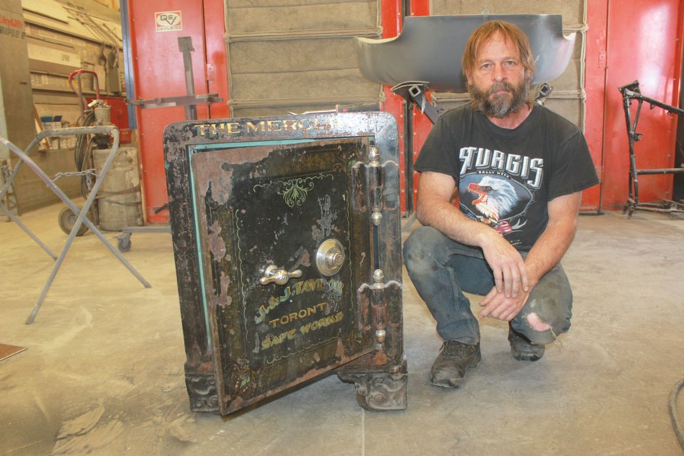 Yancey Hagel of Cactus Auto Body stands next to an old safe that he has been restoring. The safe belonged to the Estevan Mercury at one time, and may be close to 100 years old.