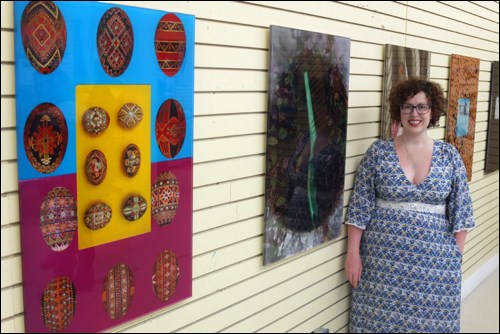 Local artist Katie Kozak with images from Baba’s House, the exhibition she and Lucien Durey created.