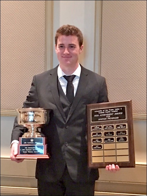 Jared Shury poses with his Air Canada Excellence Award after graduating from the University of Frase
