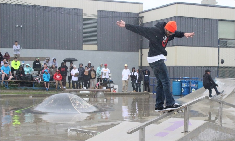 Shane McNevin of Thompson pulls off a boardslide during the 18-plus skateboarding competition.