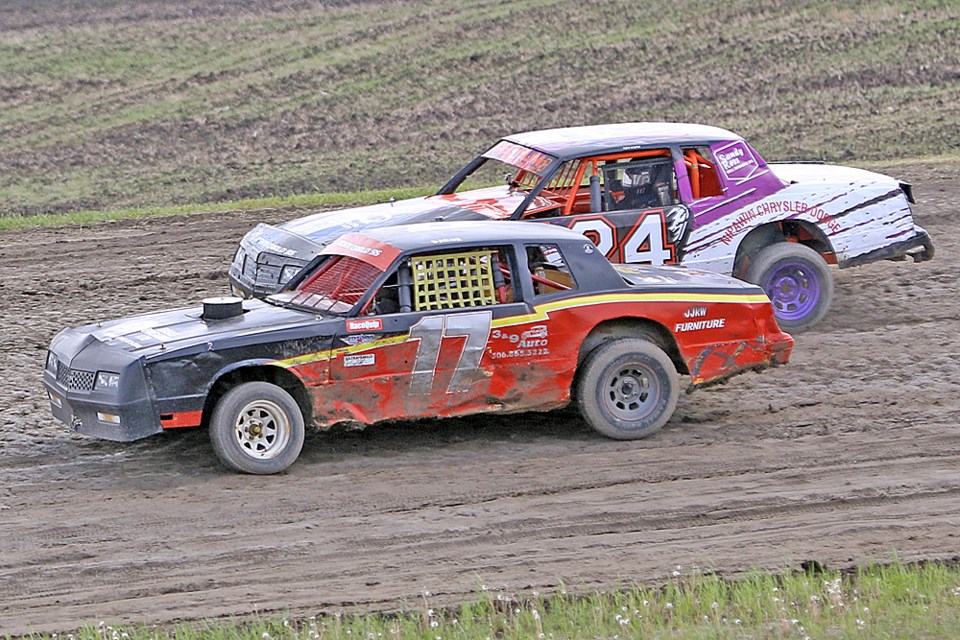 Daron Salmond, front, and Ken Wicks, back, race head-to-head during the races at the Tisdale Speedway July 11. Review Photo/Devan C. Tasa