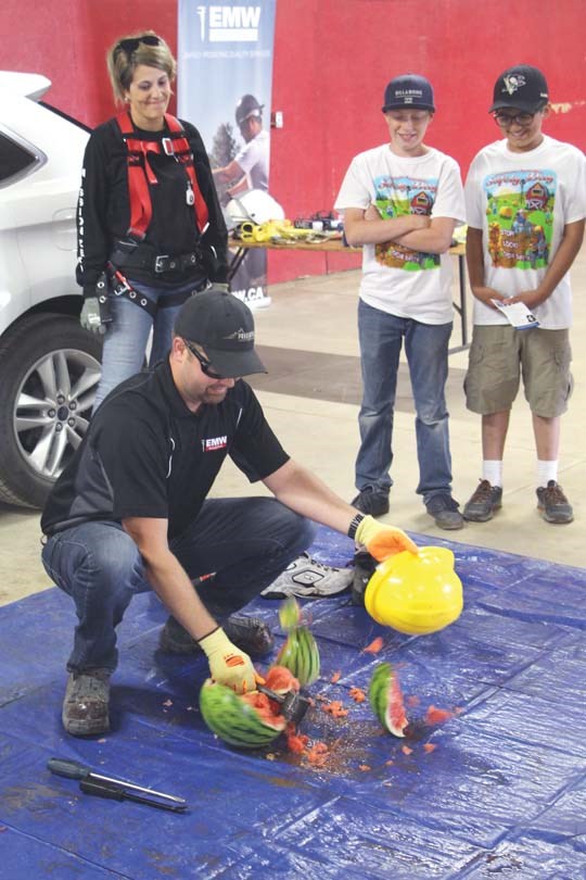 Dustin Breers from EMW Industrial demonstrates to kids why they should wear a hard hat.