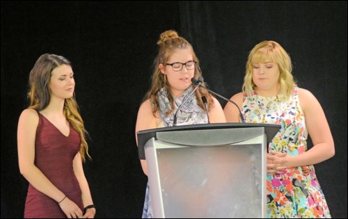 Kennedy Mielke, Becky Krentz and Kira Vlietstra, representing the Activate committee at Unity Composite High School, take turns at the podium as one of two student group guest speakers at the LSSD Student Hall of Fame celebration June 8 at Battleford.