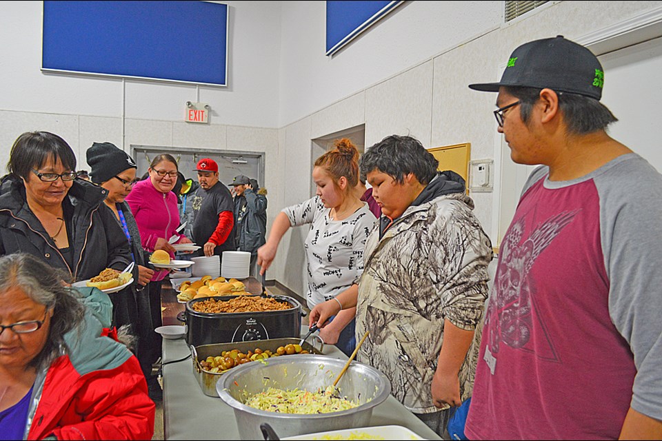 Members of the Kinistin Business Club serve dinner at a lands meeting March 10. Review Photo/Emma Meldrum