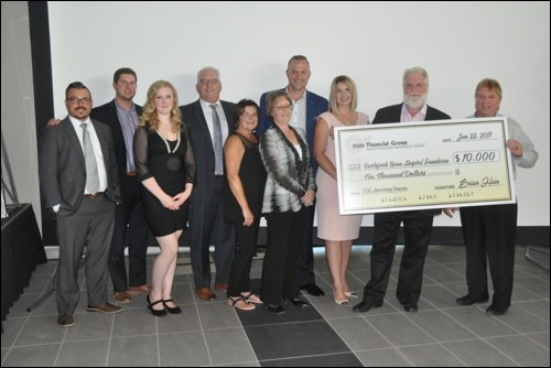 Members of Hein Financial Group including Brian Hein (second from right) presented Carey Tollefson (right) with a big cheque for the Battlefords Union Hospital in the amount of $10,000. The money will go towards the foundation’s ENT - Ear, Nose and Throat campaign. Photos by John Cairns