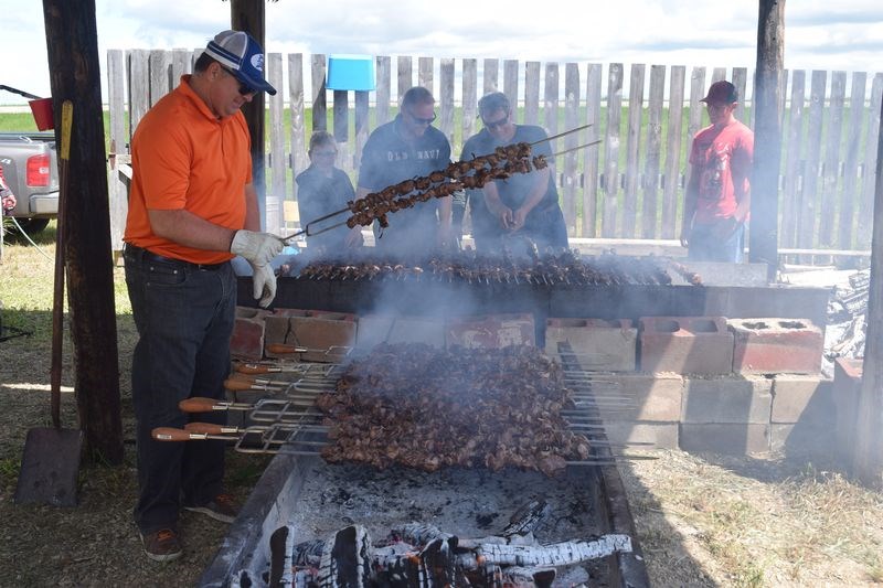 Dereck Wolkowski of Kamsack was among the cooks at the huge barbecue pits set up for the 73rd annual shishliki barbecue held by the Veregin recreation board on June 24. Among his helpers were Zack Chernoff, Eugene Remezoff, Tim Bodnarek, Darren Perepekin and Connor Bodnarek.