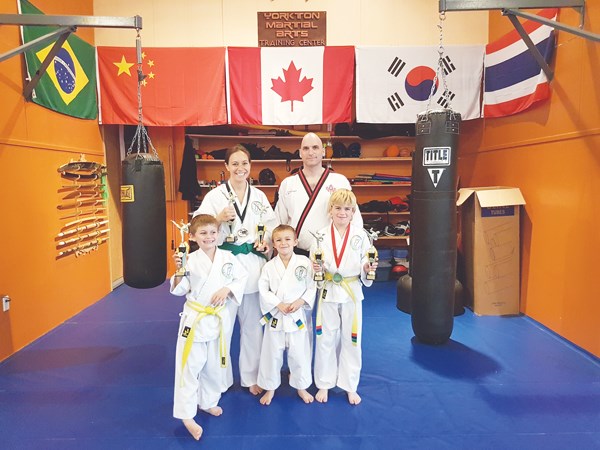On Saturday, June 24, four students from Yorkton Martial Arts Training Center competed at the Saskatchewan Martial Arts Association Provincial Championships in Regina. Students must compete and place in a minimum of three tournaments during the regular season and be ranked in the top ten of their division to qualify for a provincial championship events.The YMATC athletes represented the city well, and brought home some impressive titles. Dante Roodt is the provincial champion in weapon sparring.Ane Roodt is the provincial champion in forms & point sparring, and the runner up in weapon sparring.Isaac Forster is the provincial champion in point sparring and weapon sparring, and the runner up in forms.Pictured left to right: Dante Roodt, Ane Roodt, Trey Roodt, Master Forster, Isaac Forster as they show their winnings back at home.