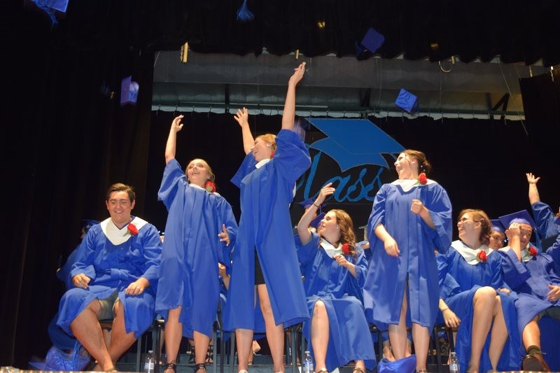 At the conclusion of the KCI graduation program, the graduates jumped for joy and flung their caps into the air.