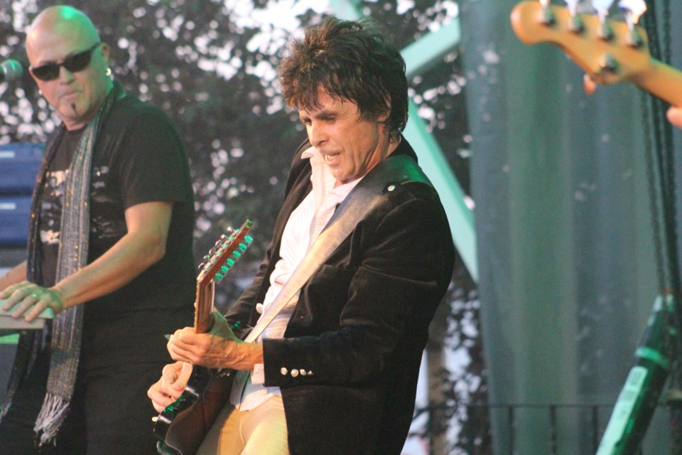 Prism’s Al Harlow riffs on his guitar during their set at Tisdale's Rockin' The Square. The July 7 event saw rock bands Prism, Headpins and Honeymoon Suite perform. Review Photo/Christopher Lee