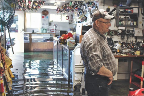 Gerry Angell in the flooded shop of Angell’s Marina in Denare Beach last week.
