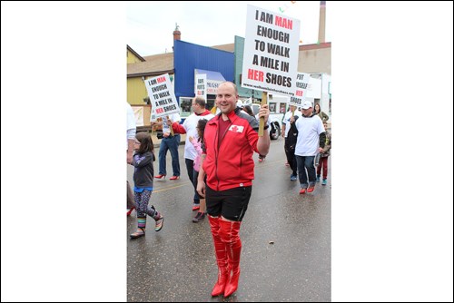 Aaron Christie went the extra mile during the Women’s Resource Centre’s Walk a Mile in Her Shoes event, held June 29. The event, which saw men walk in uptown Flin Flon in bright red high heel shoes, raised more than $8,000 for the centre. - PHOTO BY ERIC WESTHAVER