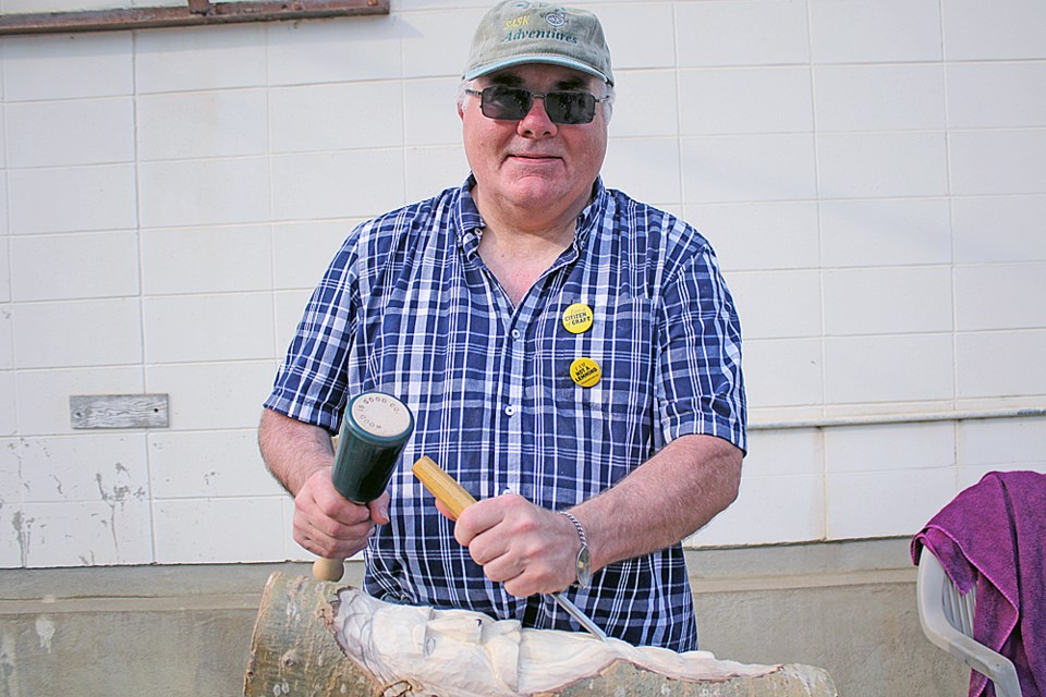 Jim Mason, who carves steampunk-theme animals and faces in pieces of poplar, was one of the artists at the Back Alley Tour in Melfort July 20. Review Photo/Devan C. Tasa