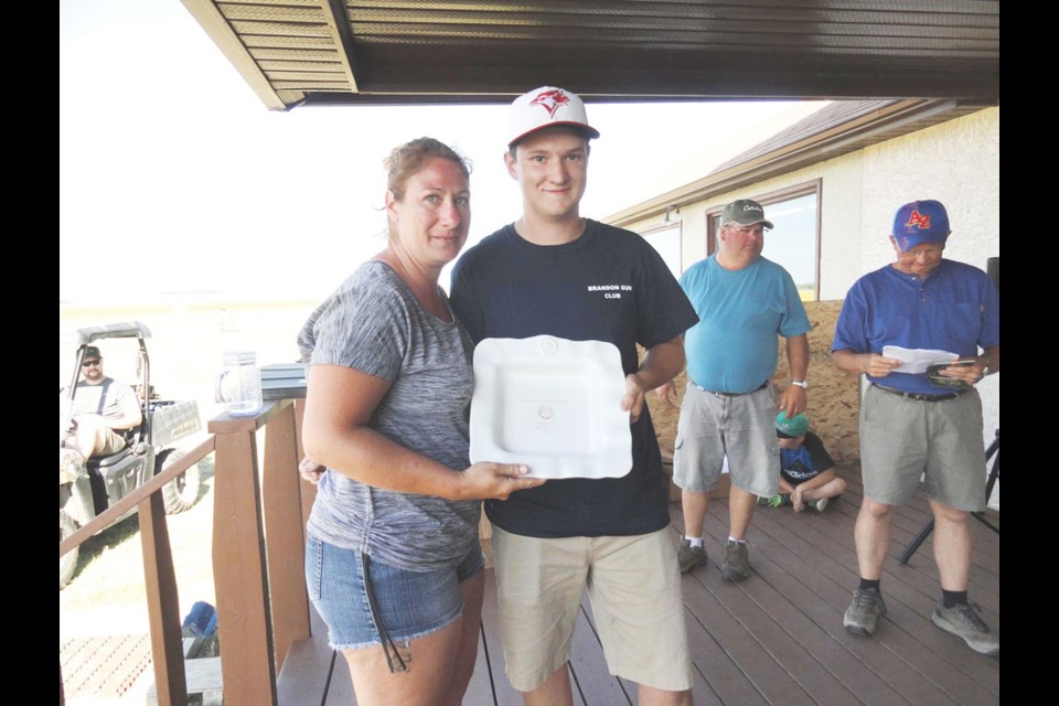 JPG Nicole Decorby president of Saskatchewan Trapshooting Association presenting High All Around Championship Trophy to Logan King. Photo submitted